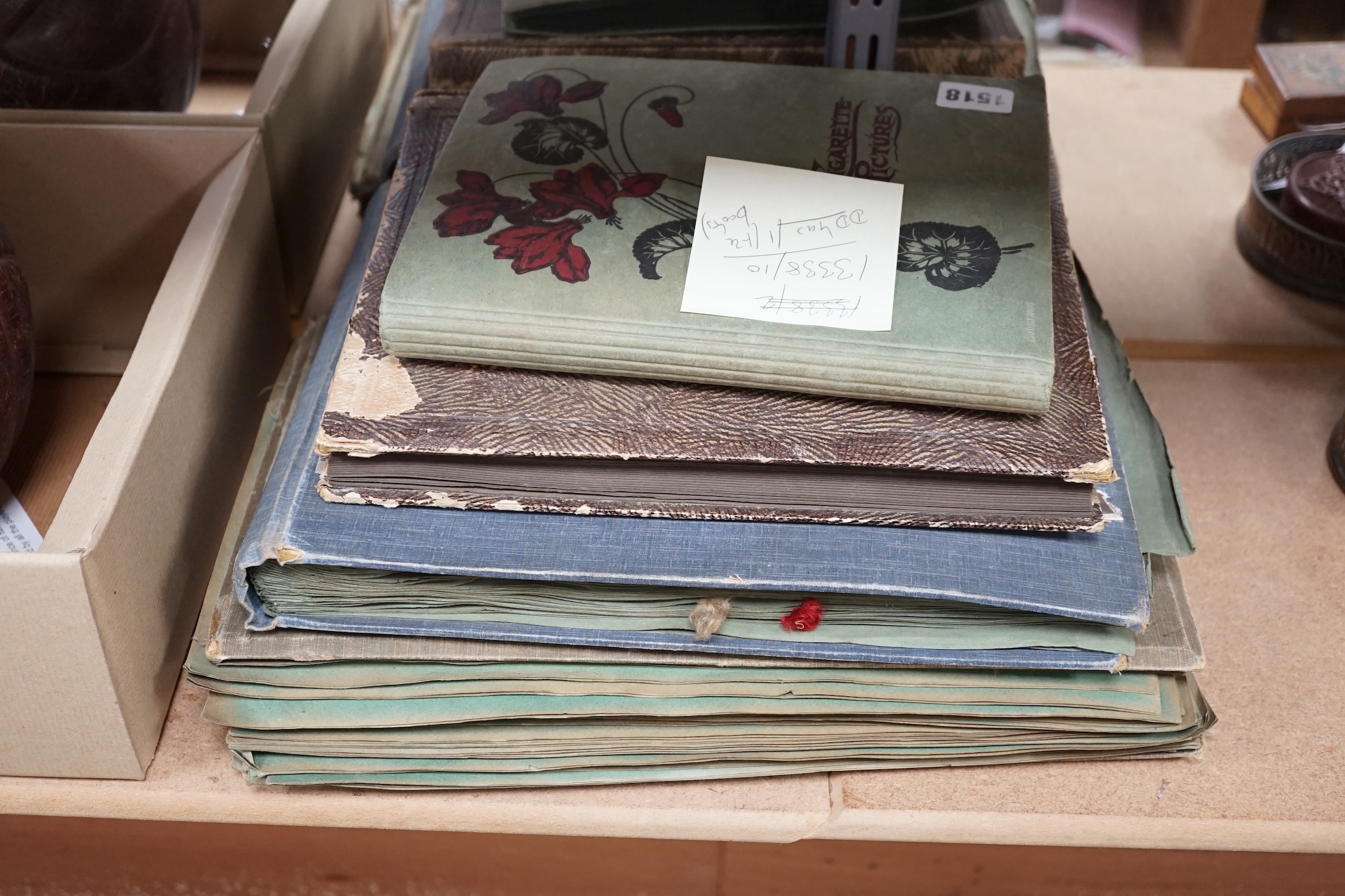 Two postcard albums, one cigarette card album and a scrap album